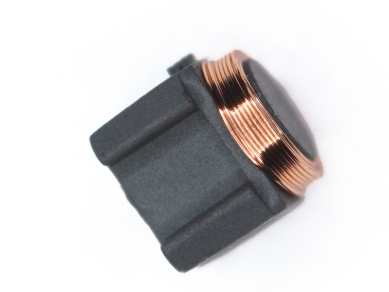 Close-up of a 13.56 MHz NFC/RFID transponder inlay with copper antenna coil — NTAG21x-class Type-2 chip hardware