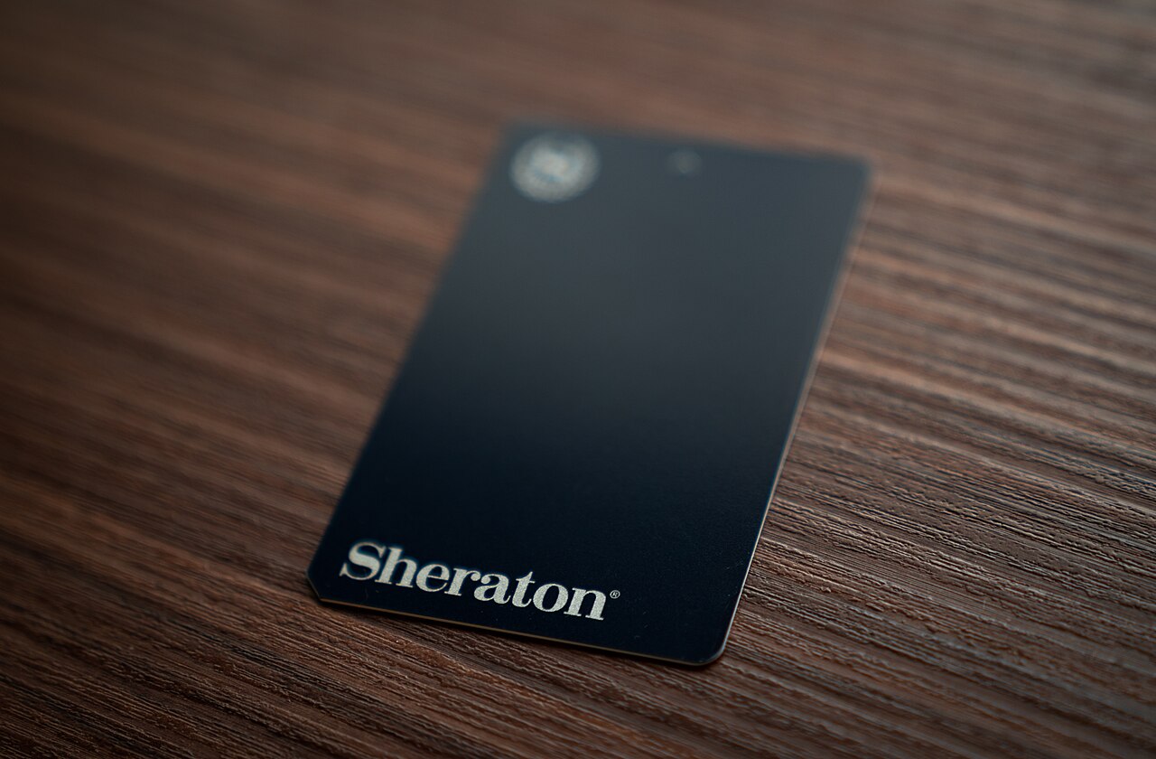 Sheraton-branded hotel key card with matte-black finish and foil-stamped logo — a real-world example of the artwork and printing brief this checklist produces